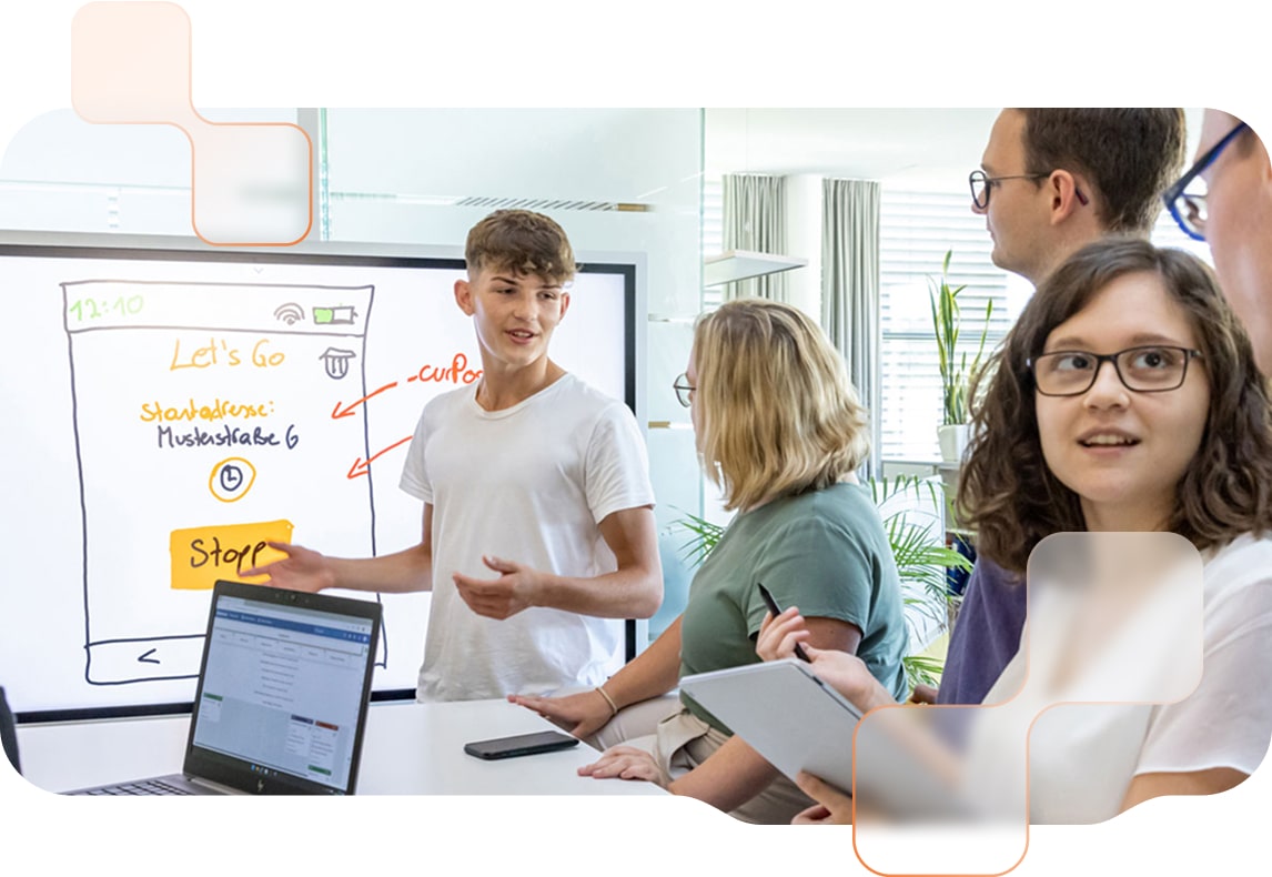 BMD Future Lab Praktikantinnen und Praktikanten besprechen ihre Projekte und benutzen dabei Laptops und ein digitales Whiteboard..